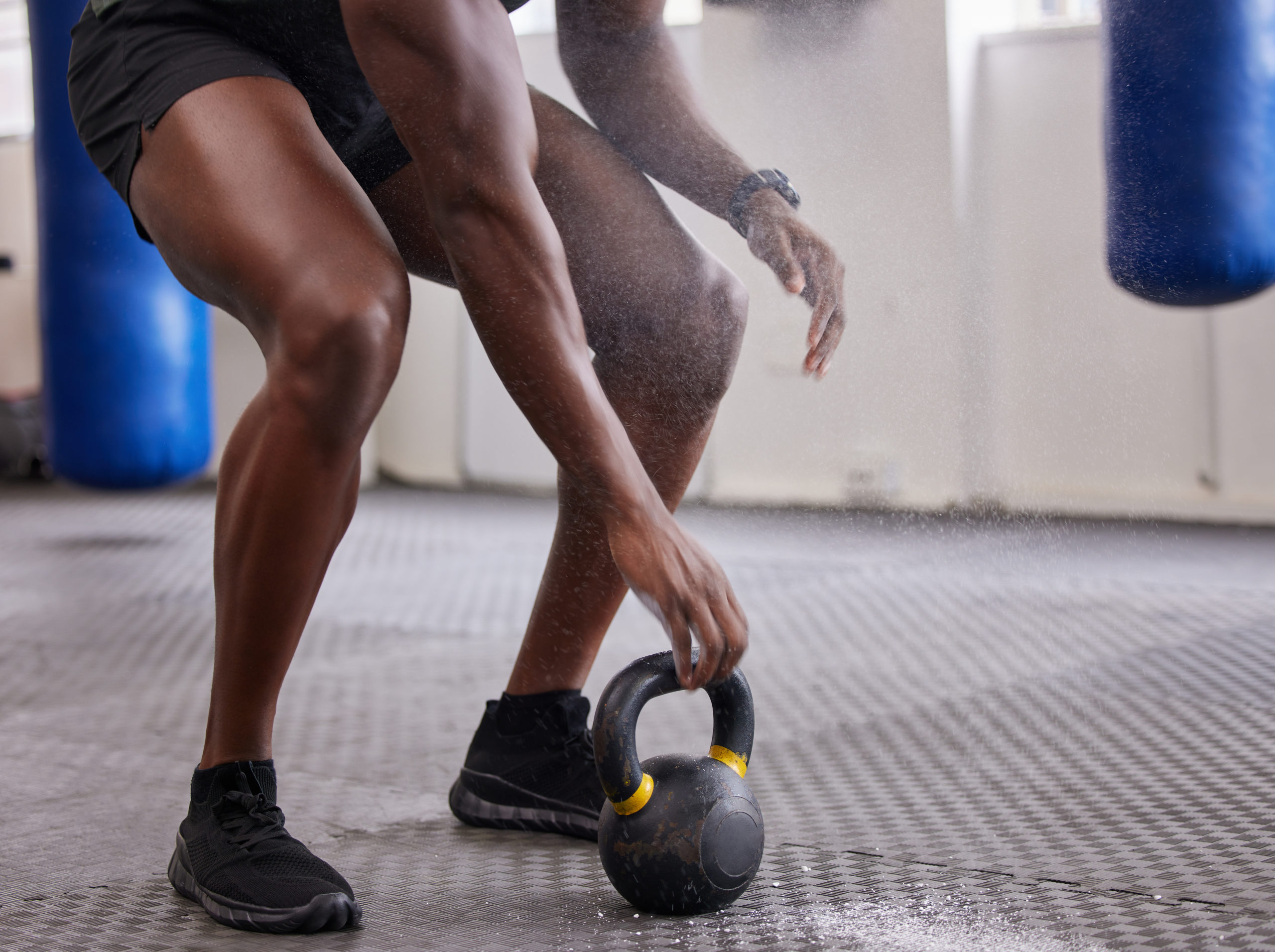 Kettlebell, hands and legs of man training for weightlifting, fitness workout and sports challenge .